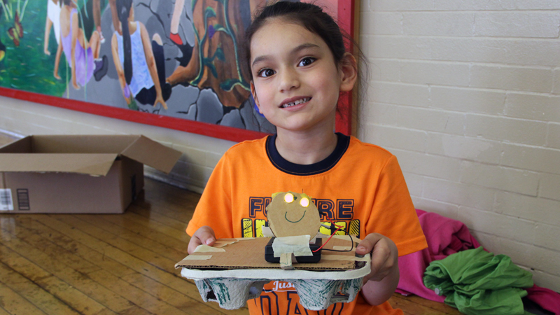 A student shows off her turtle.