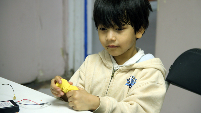 Exploring Squishy Circuits at an ArtMakerSpace event.