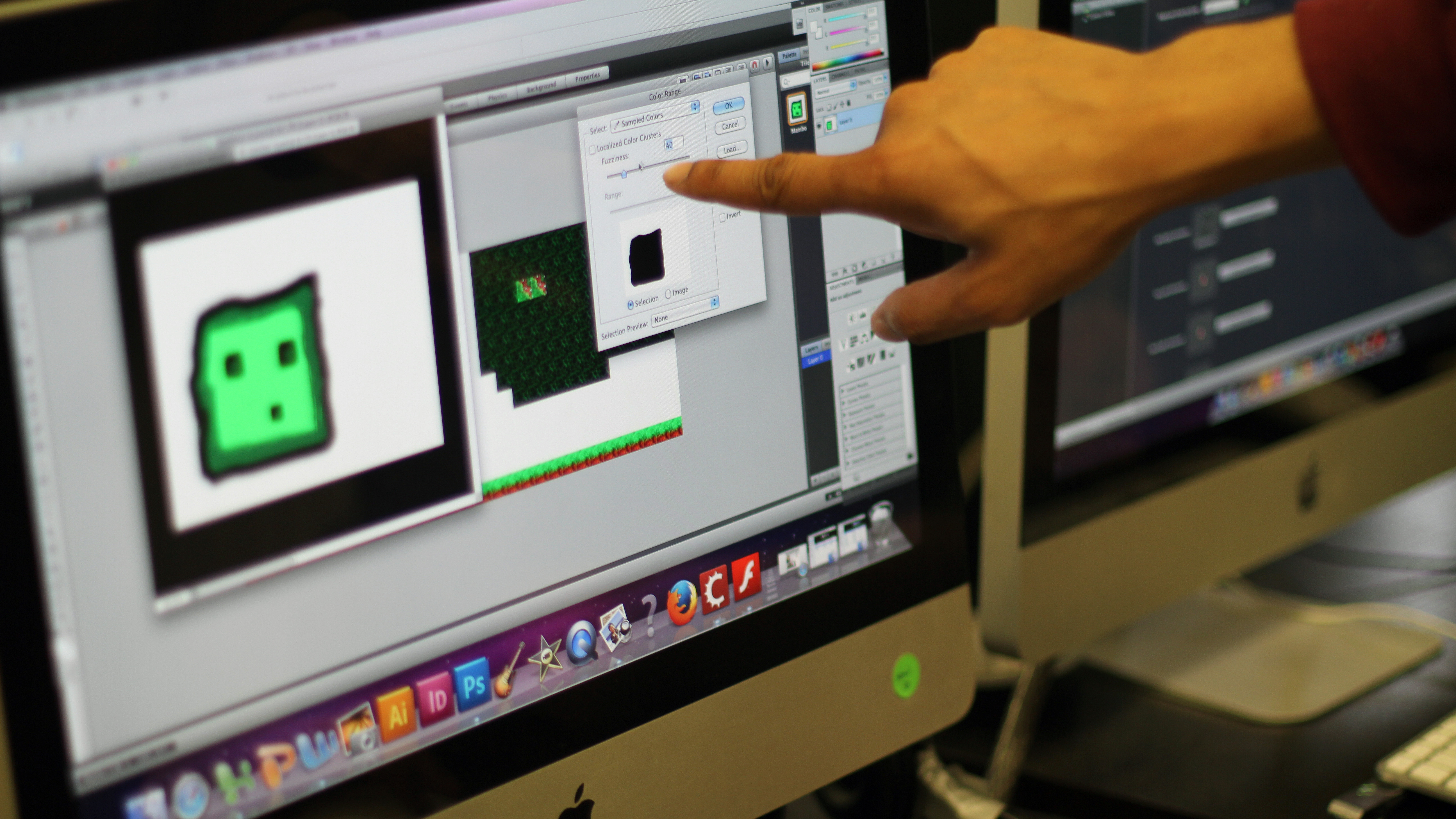 An artist-teacher discusses game design with a student.
